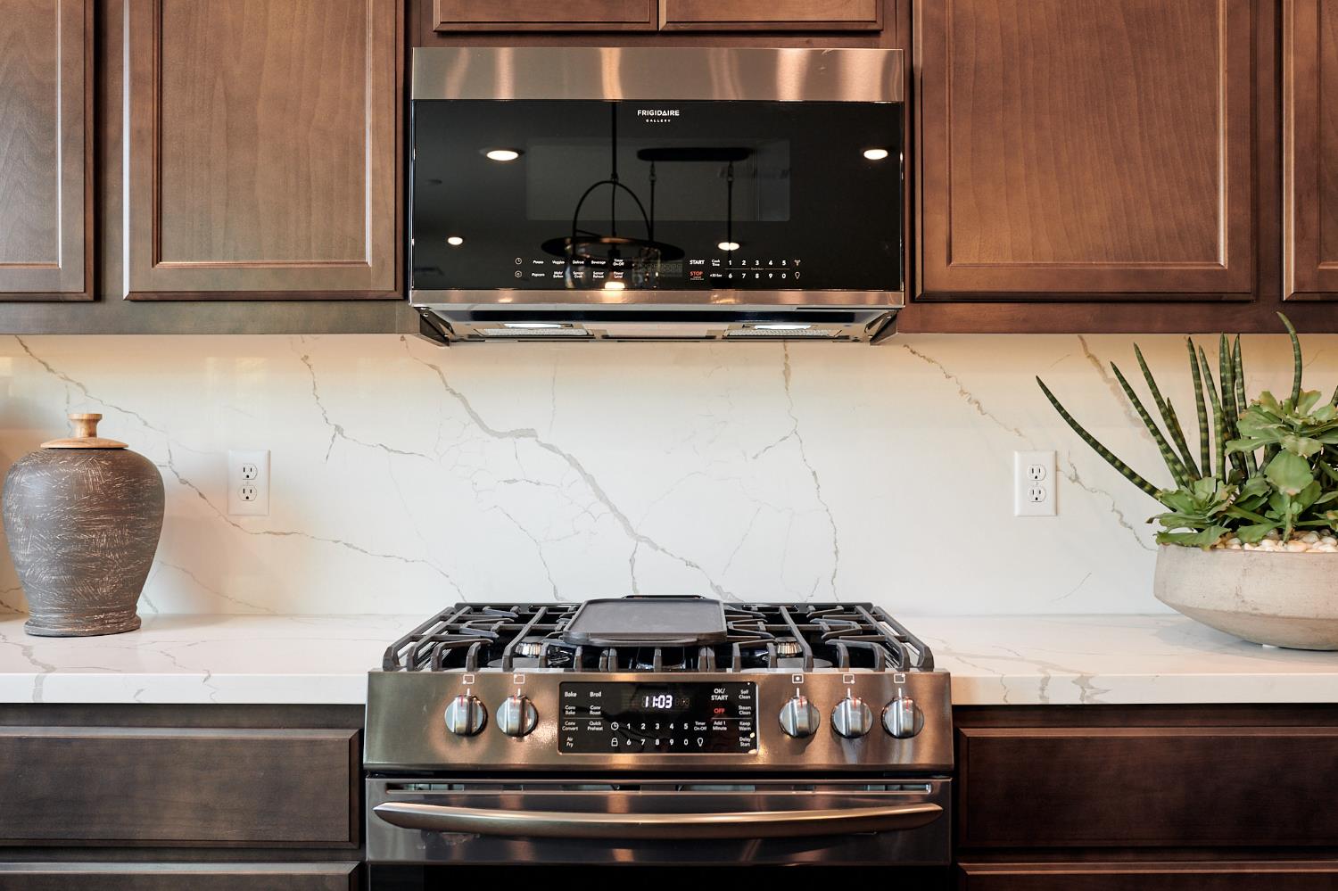 4719 Ariel Street Keyes, CA 95328 - Photo 9 of 22 a close view of a stove a microwave and cabinets