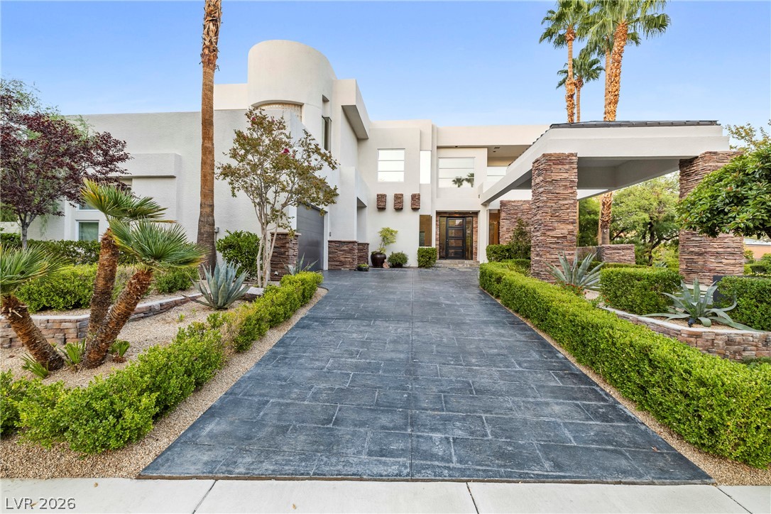 2000 Grouse Street Las Vegas, NV 89134 - Photo 50 of 89 A grand entrance with an impressive stamped concrete driveway and meticulously manicured landscaping welcomes you home.