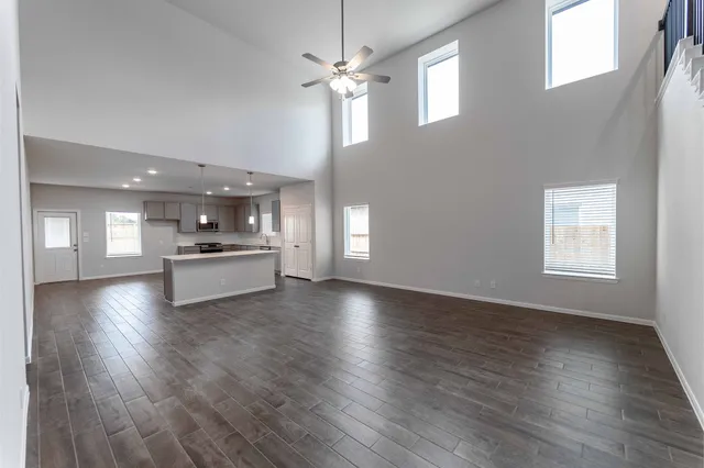 a view of cabinets and kitchen with sink wooden floor