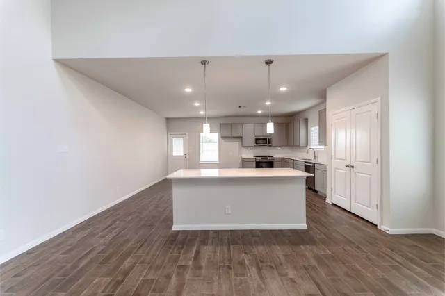 a view of kitchen with wooden floor and electronic appliances