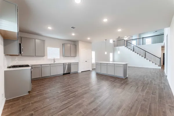 a view of kitchen with wooden floor and electronic appliances