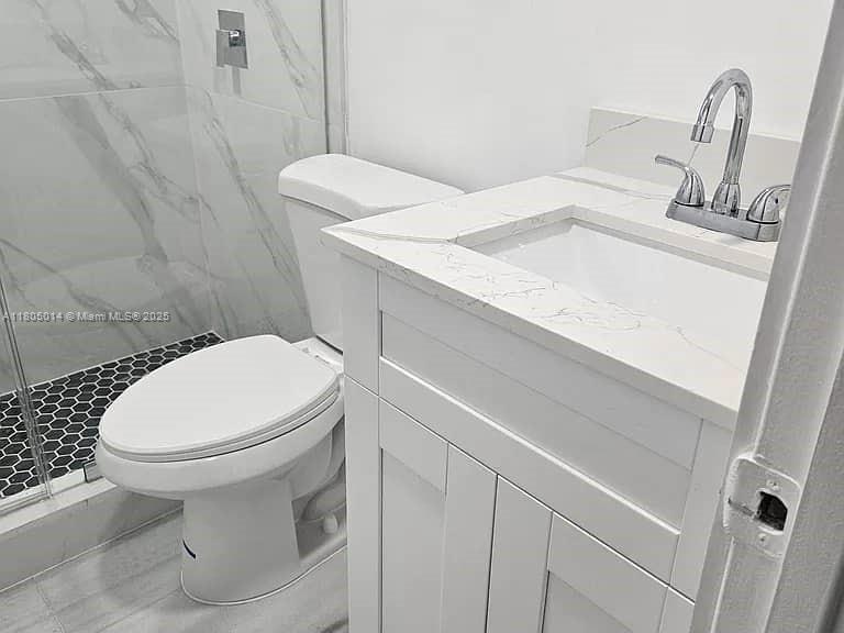 Flagami Miami, FL 33144 - Photo 5 of 14 a bathroom with a sink a toilet and a mirror