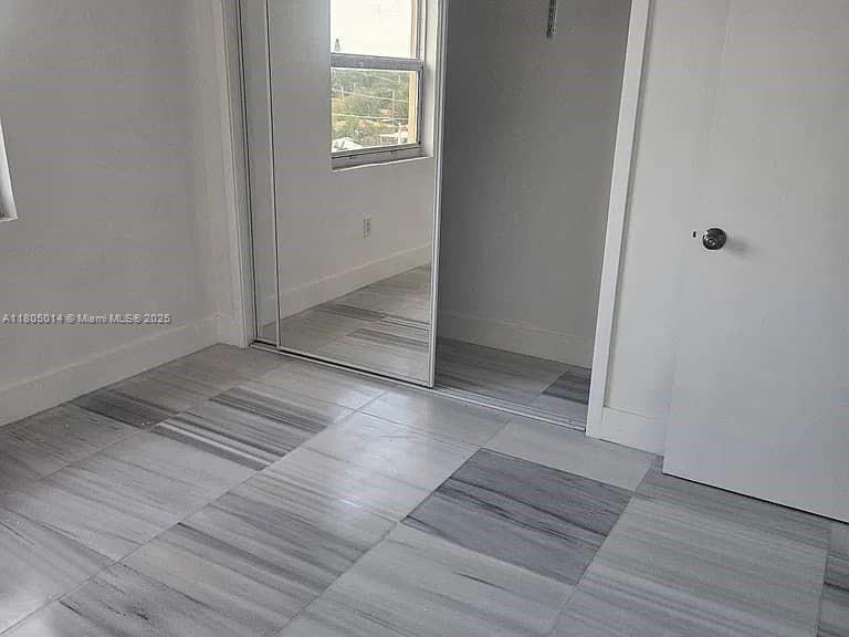 Flagami Miami, FL 33144 - Photo 10 of 14 an empty room with wooden floor and windows