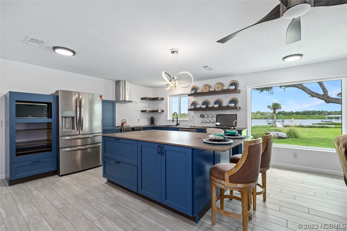 Undisclosed Address Edgewater, FL 32141 - Photo 12 of 34 a kitchen with stainless steel appliances a stove a sink dishwasher and a refrigerator