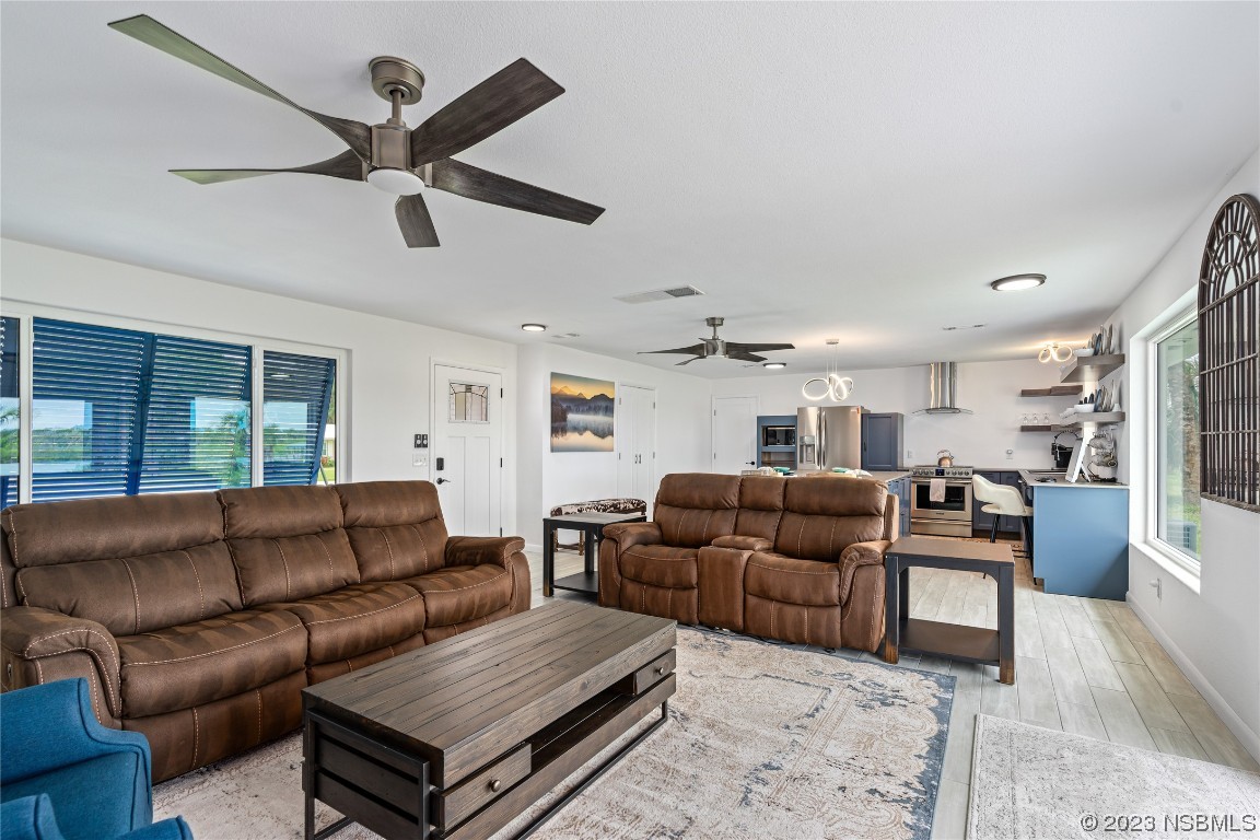 Undisclosed Address Edgewater, FL 32141 - Photo 16 of 34 a living room with furniture and a ceiling fan