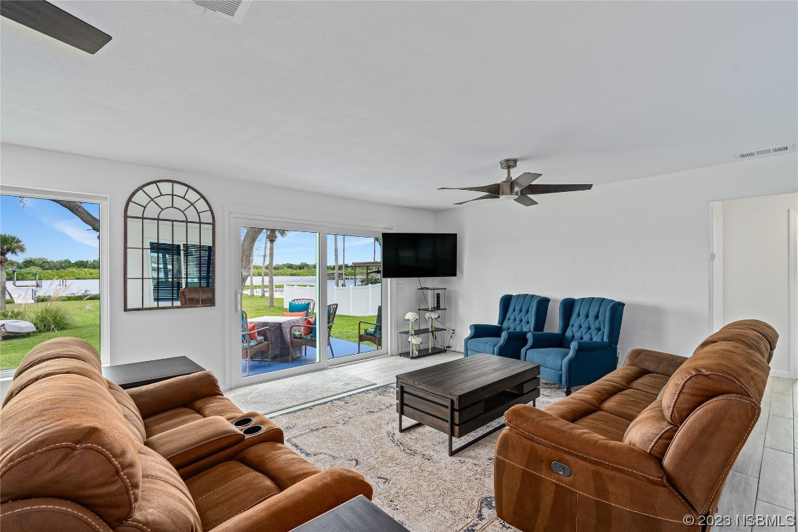 Undisclosed Address Edgewater, FL 32141 - Photo 18 of 34 a living room with furniture ceiling fan and a flat screen tv