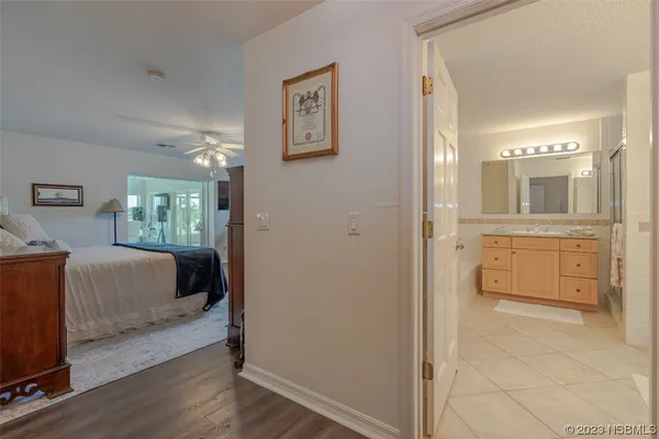 a en suite bathroom with a granite countertop sink mirror and vanity