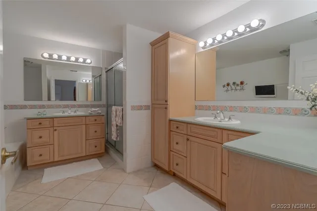 a spacious bathroom with a granite countertop sink mirror and cabinets