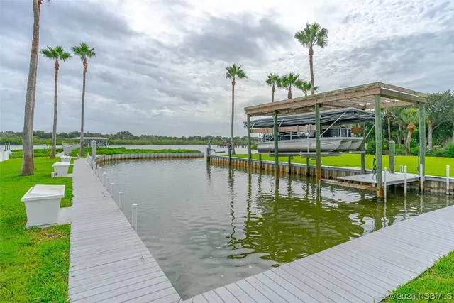 a view of a patio with lawn chairs floor to ceiling window and wooden floor