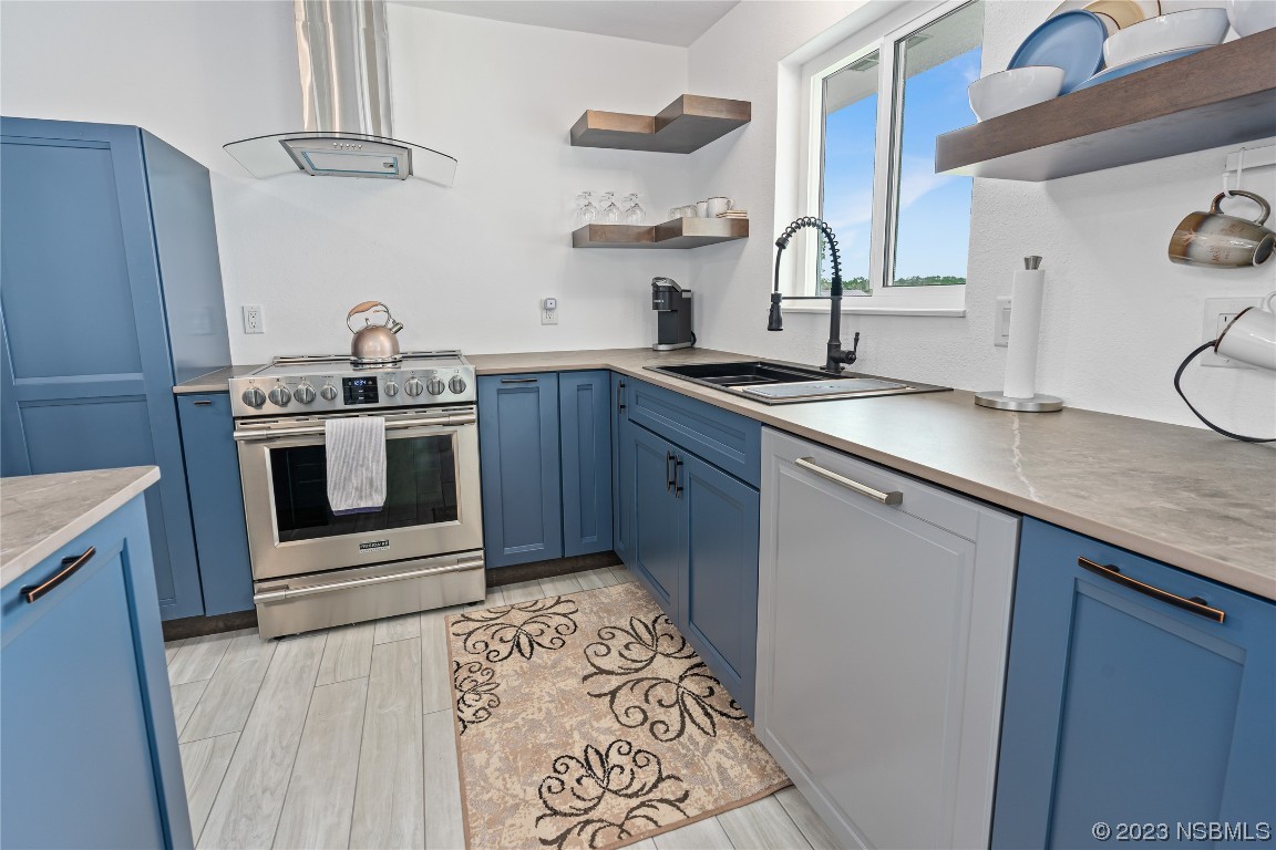 Undisclosed Address Edgewater, FL 32141 - Photo 10 of 34 a kitchen with stainless steel appliances granite countertop a sink stove and refrigerator