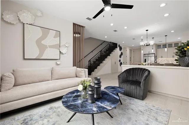a living room with furniture and a chandelier