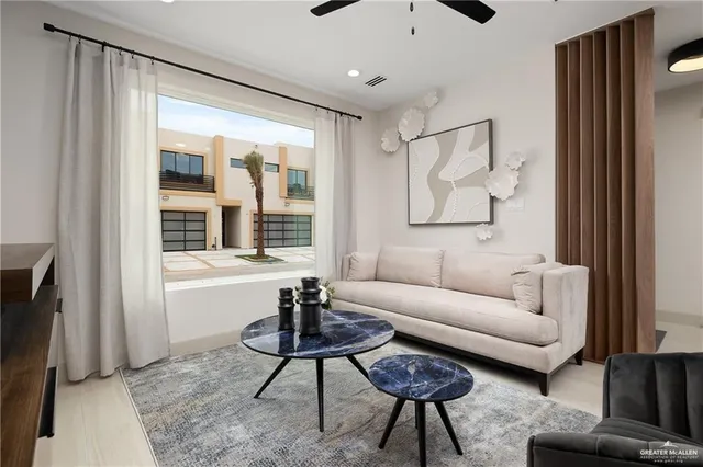 a living room with furniture and a large window