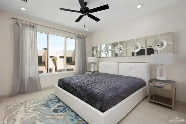 a bedroom with a large bed and a window