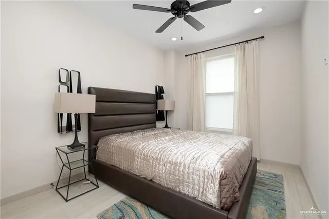 a bedroom with a bed a chandelier and a window