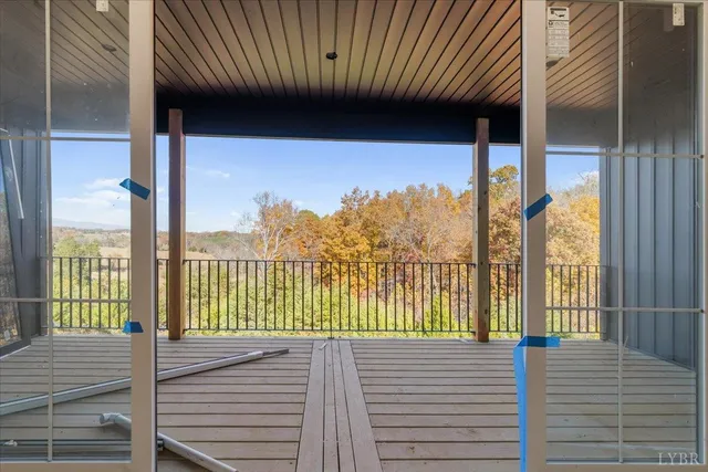 a view of a balcony with floor to ceiling window wooden floor