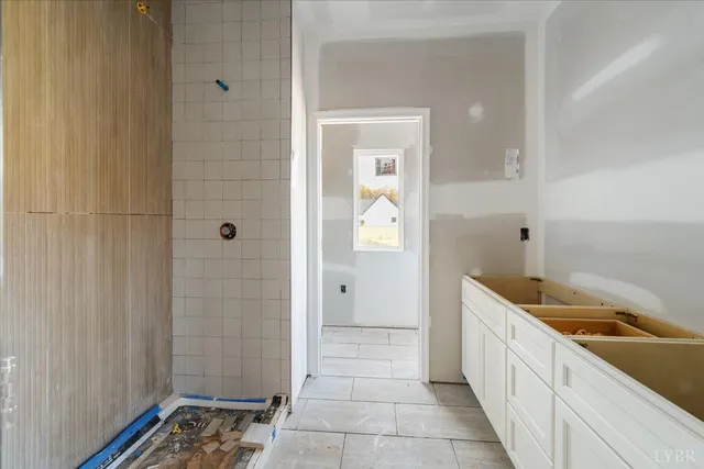 a bathroom with a window and a shower