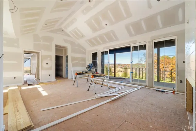a room with pool table and large windows