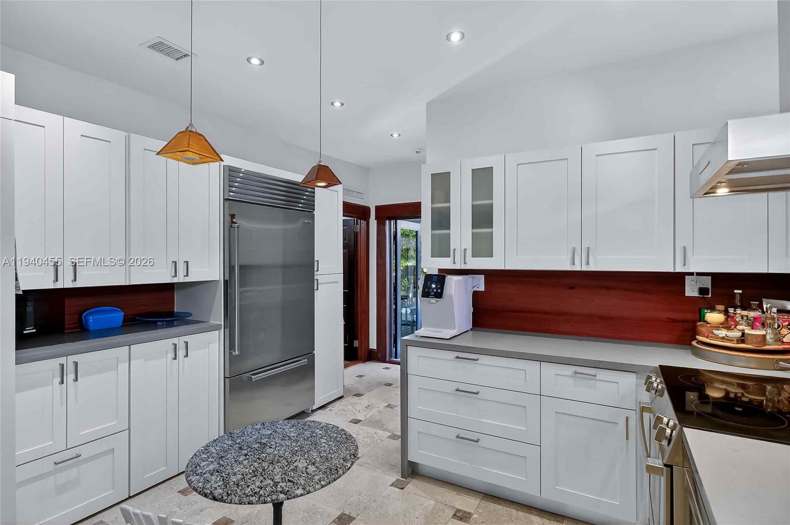 452 Southwest 21st Road Miami, FL 33129 - Photo 12 of 51 a kitchen with stainless steel appliances granite countertop a refrigerator and a stove
