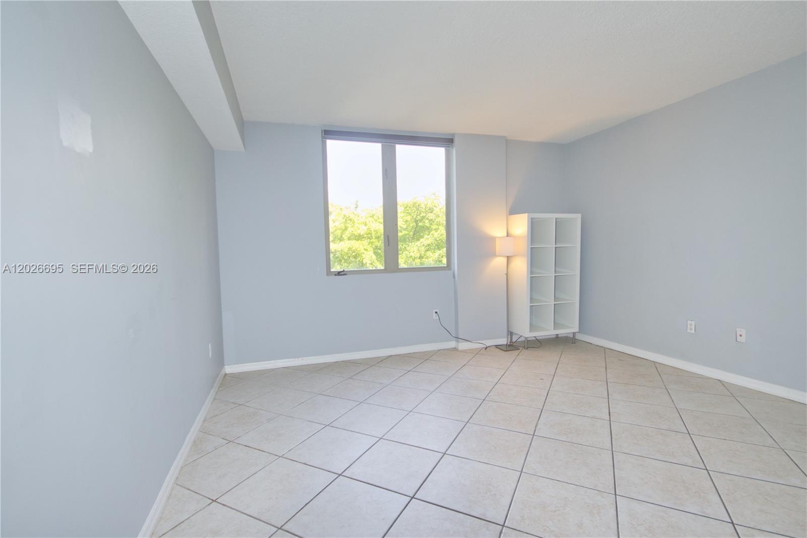 2630 Southwest 28th Street, Unit 22 Miami, FL 33133 - Photo 5 of 9 an empty room with windows