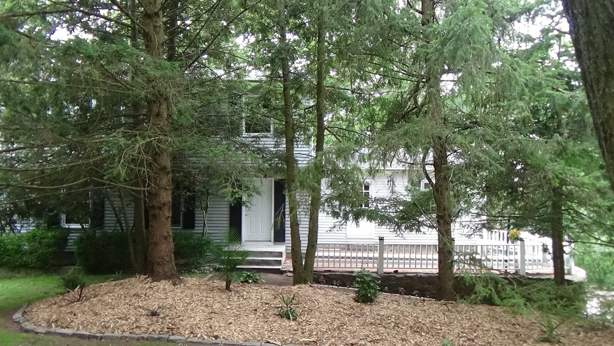 a view of a house with a tree in the background