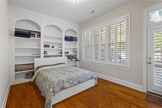 a bedroom with a large bed and a window