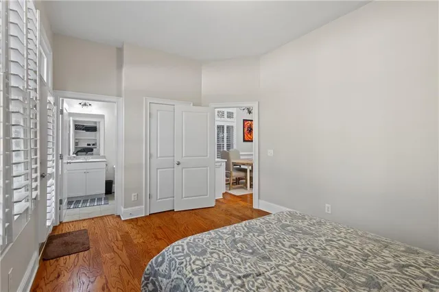 a bedroom with a bed and a view of kitchen