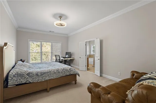 a bedroom with a bed and painting on the wall