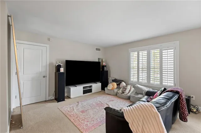 a living room with furniture and stairs