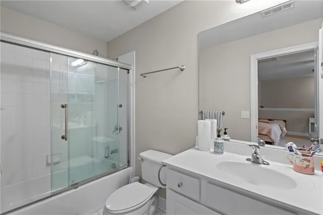 a bedroom with a bed a couch and dresser