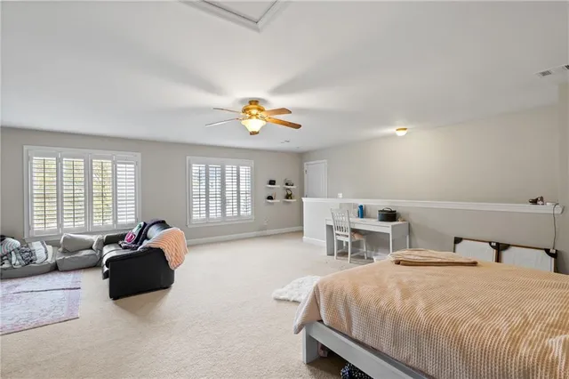 a view of a patio with table and chairs potted plants and large tree