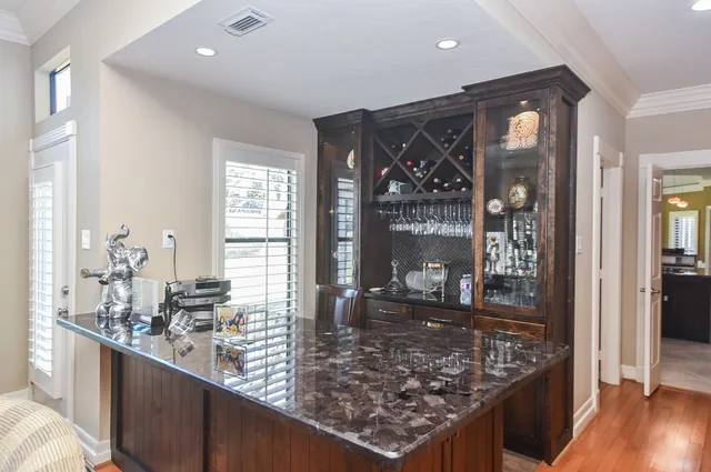a kitchen with stainless steel appliances granite countertop wooden cabinets a sink and a stove