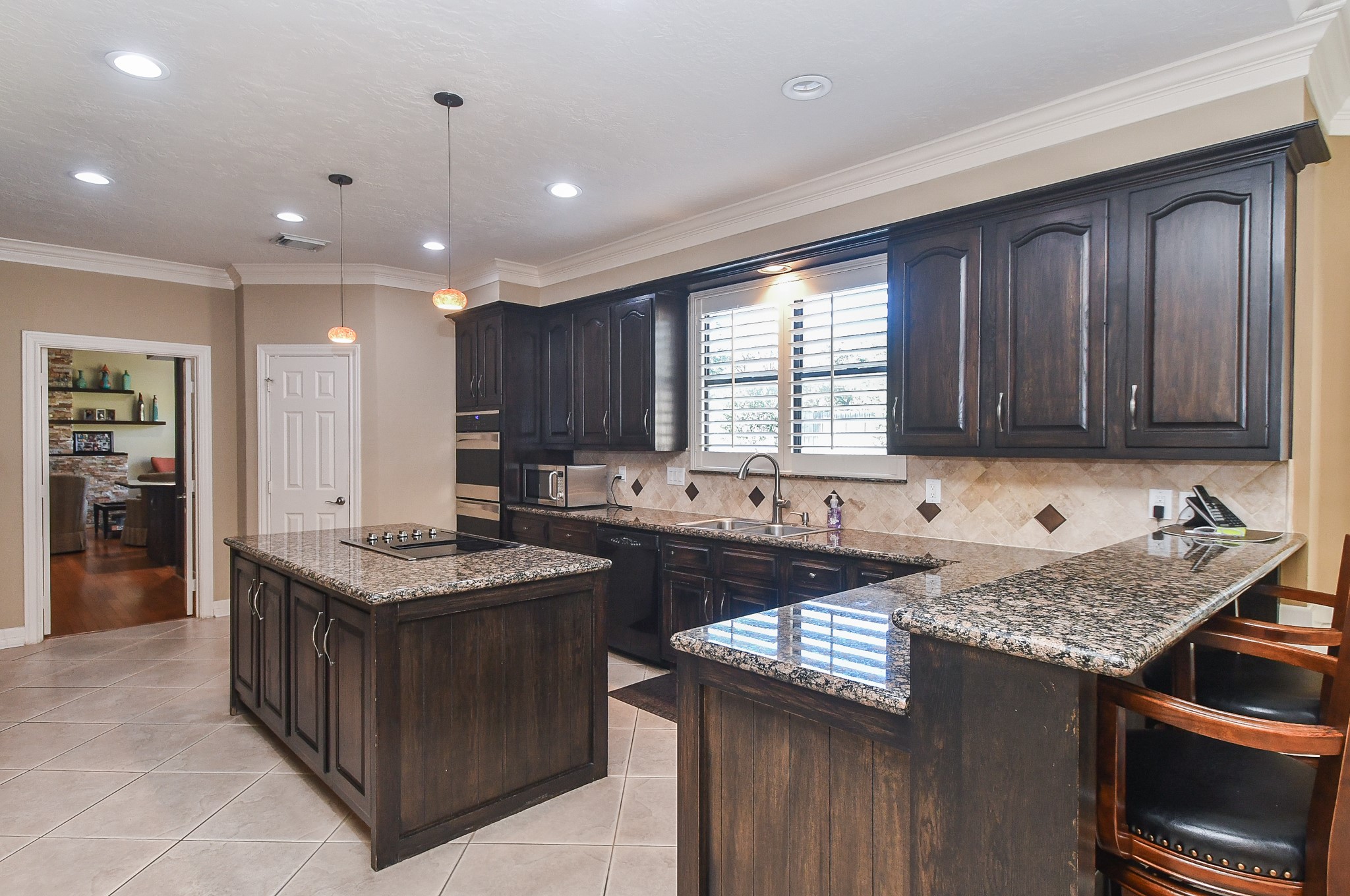 20102 Gable Point Drive Katy, TX 77450 - Photo 15 of 42 a kitchen with granite countertop kitchen island stainless steel appliances a sink stove and cabinets