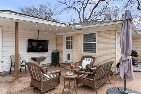a outdoor living space with furniture and a flat screen tv