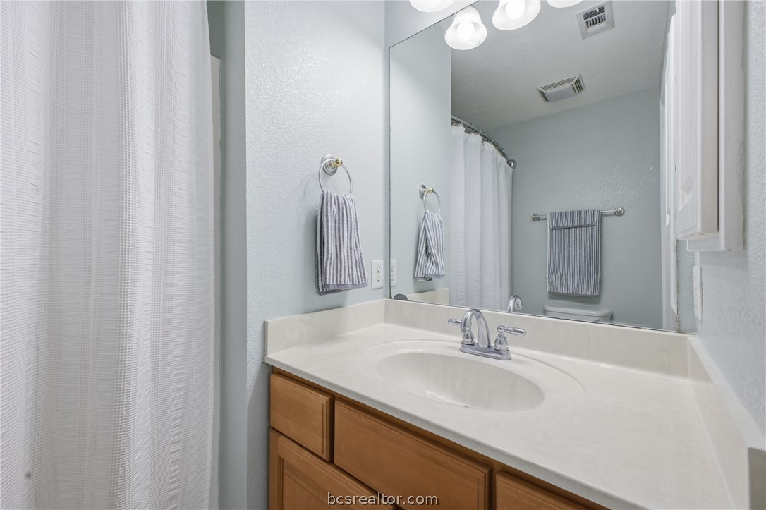 1000 Spring Loop, Unit 2105 College Station, TX 77840 - Photo 16 of 22 a bathroom with a sink and a mirror