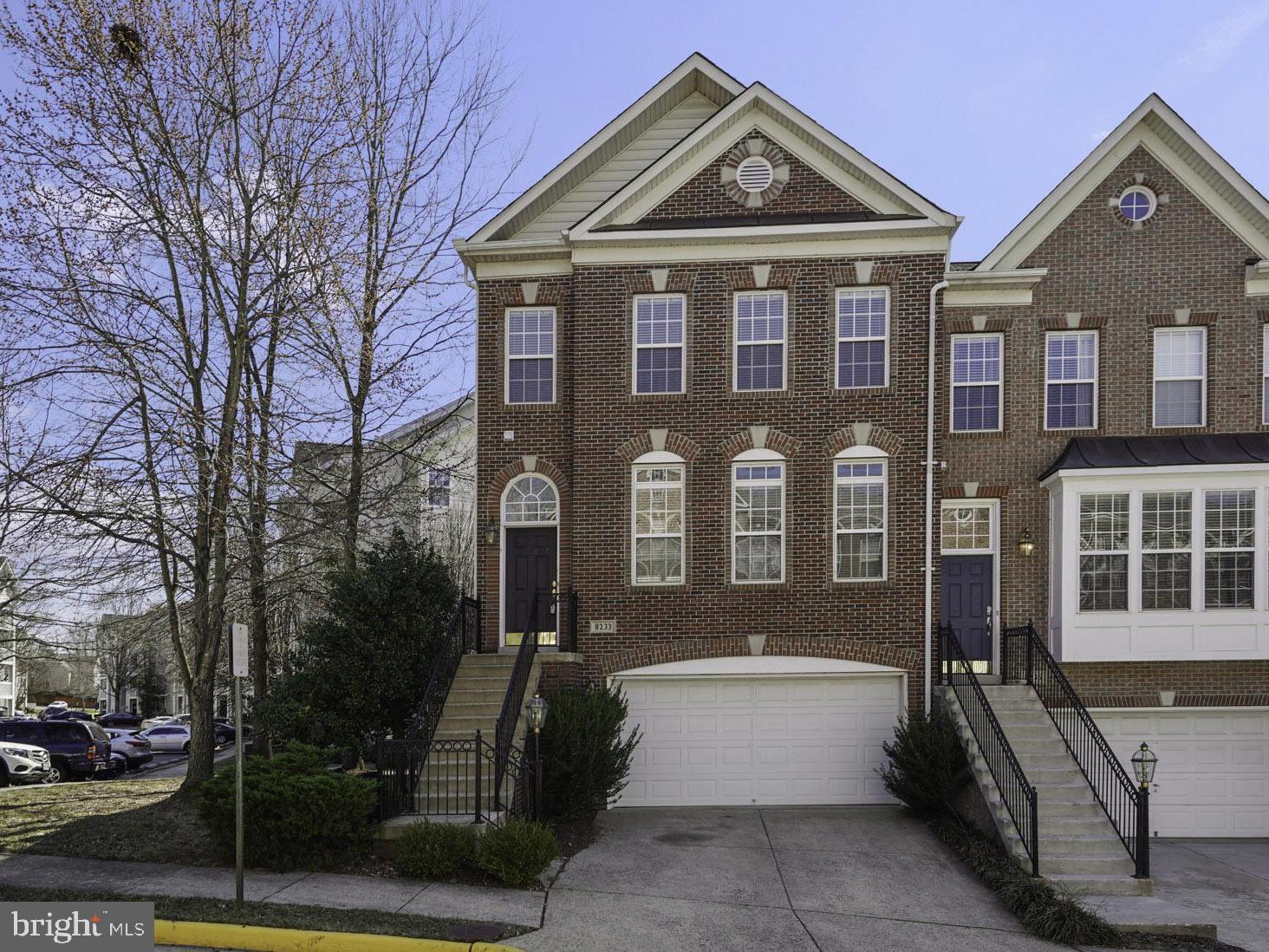 8233 Gunston Commons Way Lorton, VA 22079 - Photo 1 of 24 a front view of a house with a yard