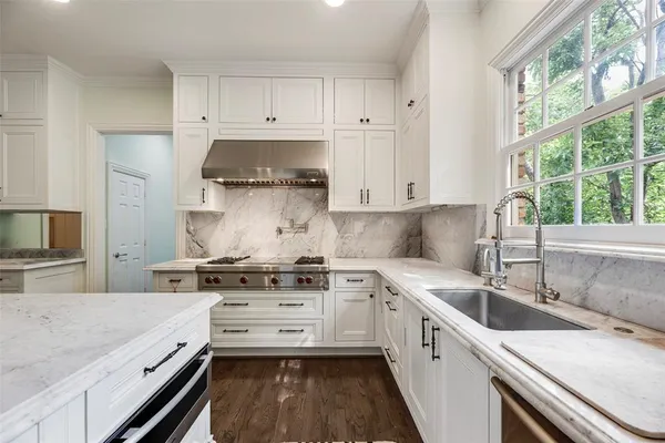 a kitchen with a appliances a sink and a refrigerator