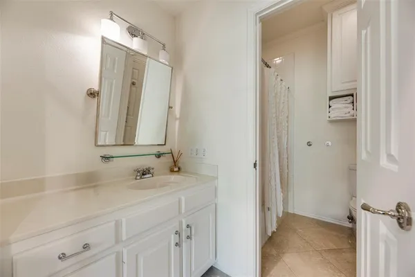 a bathroom with a double vanity sink a mirror and a bathtub