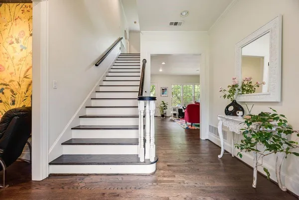 a view of entryway and hall with wooden floor