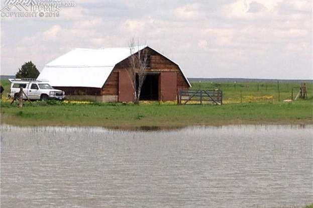 13495 South Lauppe Road Yoder, CO 80864 - Photo 1 of 12 Spring and summer with large pond.