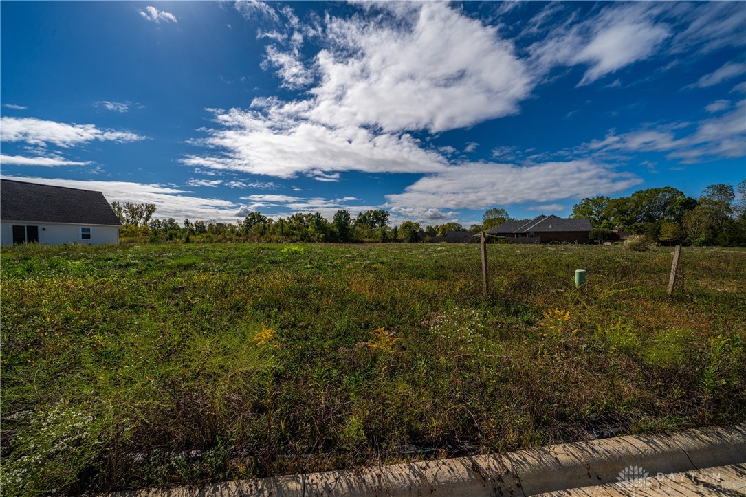 1503 Kingsgate Road Springfield, OH 45503 - Photo 2 of 10 An expansive green field under a vast blue sky offers an idyllic setting for future development.