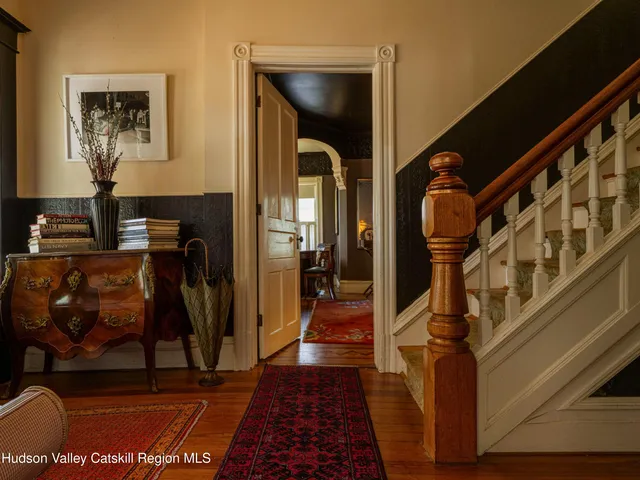 a view of a dining room with furniture and a window