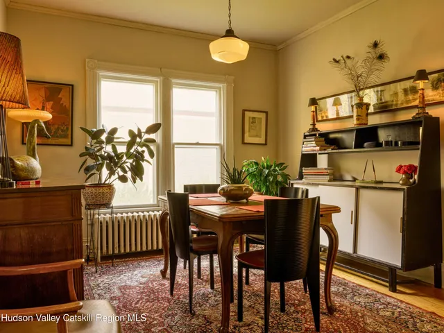 a dining room with furniture and wooden floor