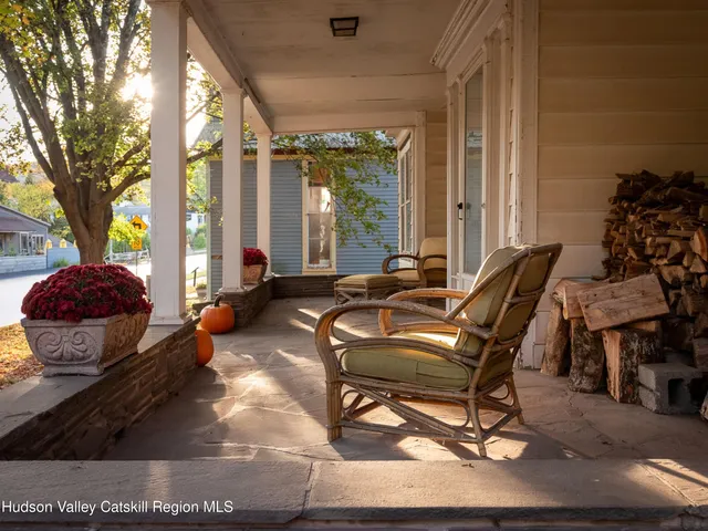 a living room filled with furniture and a large window