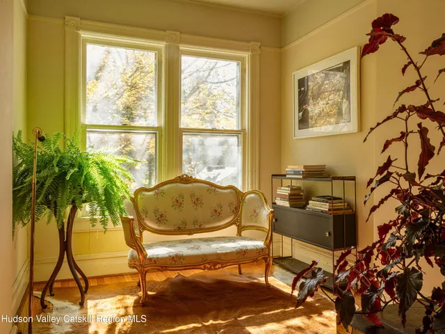 a living room with furniture and a potted plant