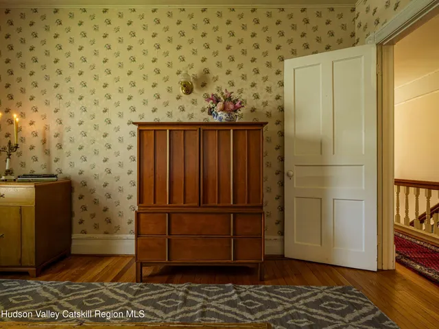 a bedroom with furniture and a window