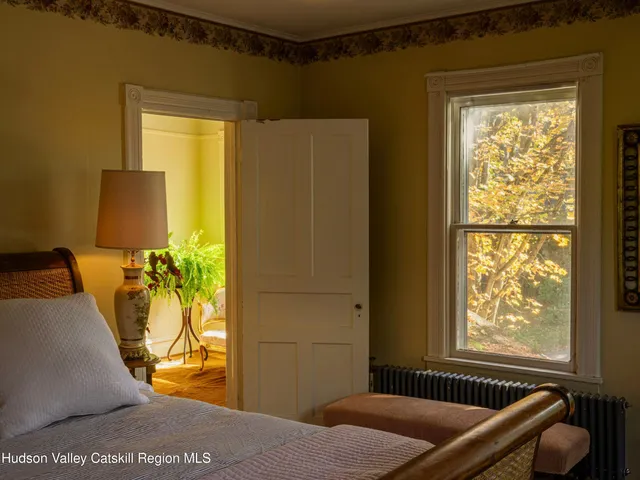 a bedroom with a bed and a potted plant