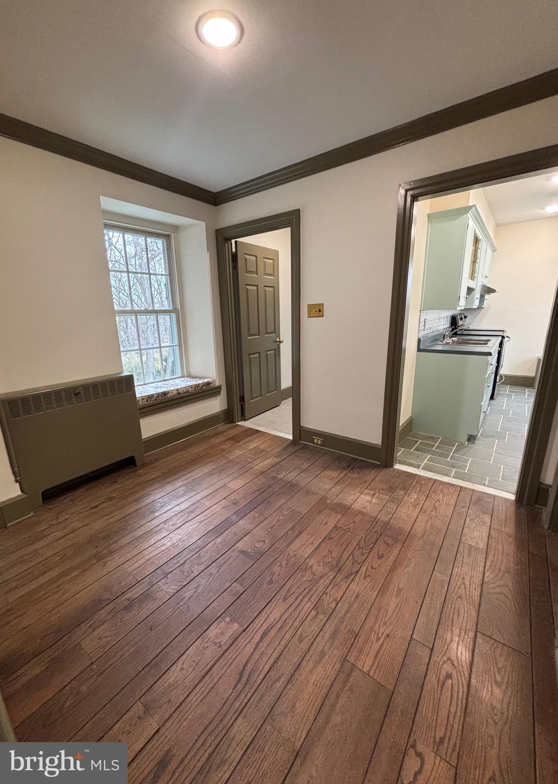 28 West Main Street, Unit 3 Elverson, PA 19520 - Photo 4 of 10 wooden floor in an empty room with a window