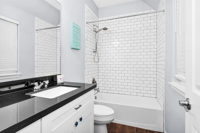 a bathroom with a sink a toilet a mirror a shower and a bathtub