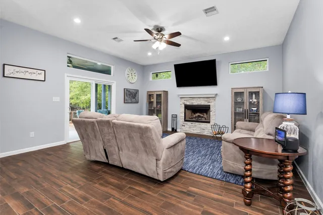 a living room with furniture fireplace and a flat screen tv