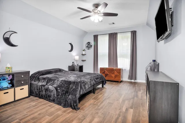 a bedroom with a bed and a flat screen tv